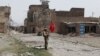 A Pakistani army soldier stands guard in Miranshah bazaar after driving out militants from Pakistan's tribal region of North Waziristan along the Afghanistan border, July 9, 2014. 