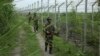 India’s Border Security Force soldiers patrol near the India-Pakistan international border fencing at Garkhal in Akhnoor, west of Jammu, India, Aug. 13, 2019. 