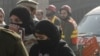 A rescue worker guides students, after they were rescued in a militant attack at Bacha Khan University, in Charsadda, Pakistan, January 20, 2016. REUTERS/Fayaz Aziz - GF20000100677